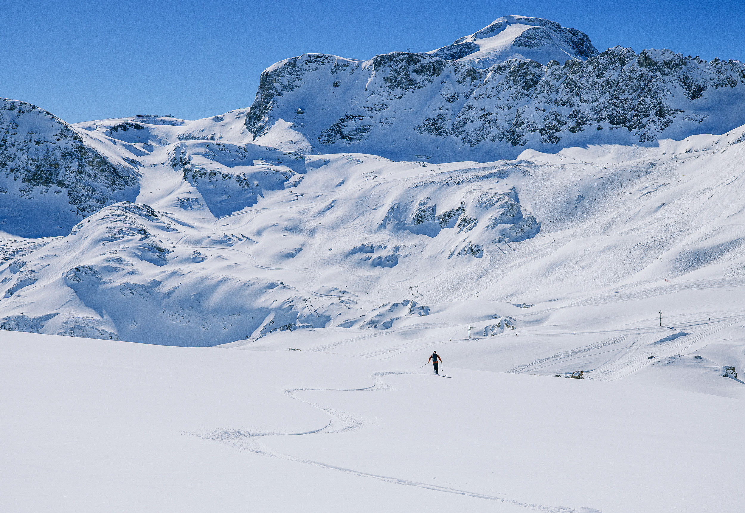 Skier on wide open run in France.